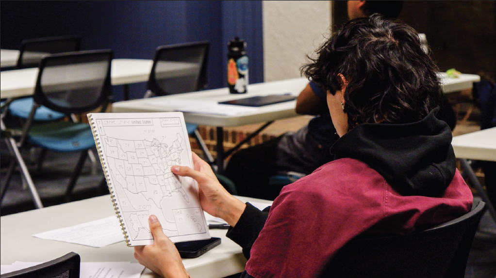 South student William Scotts feels the Braille bump labels on a map of the USA